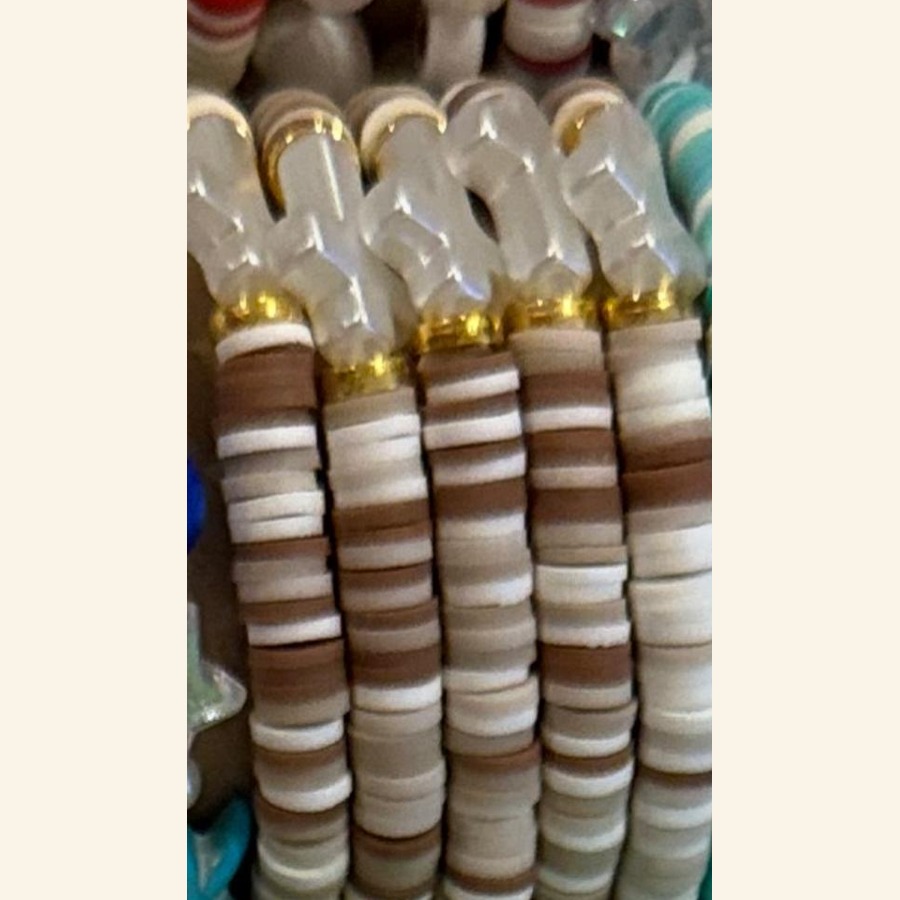 Coconut Cross bracelet with tan, cream, white, and gold details